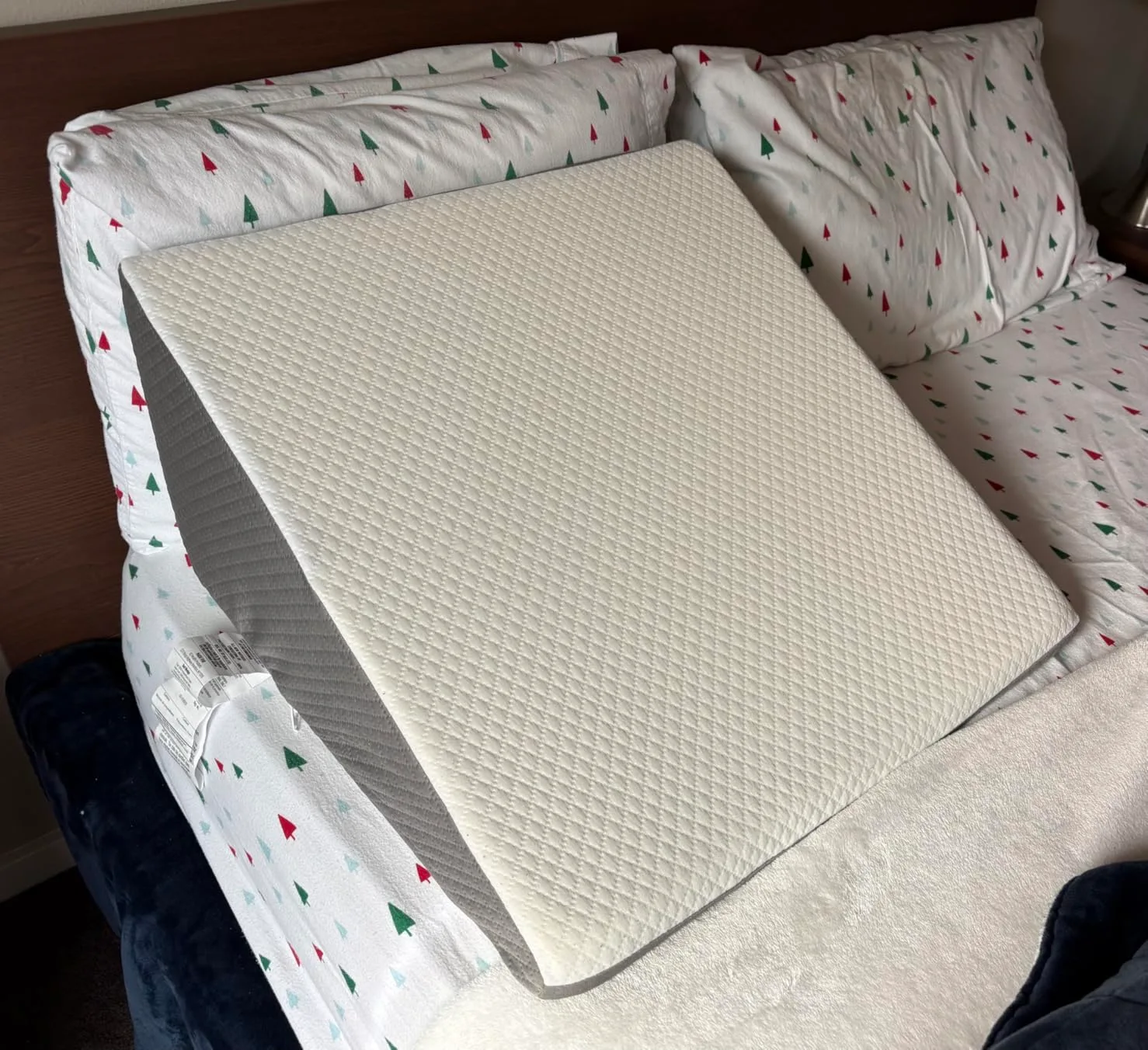 Customer photo of wedge pillow positioned on bed at an incline angle
