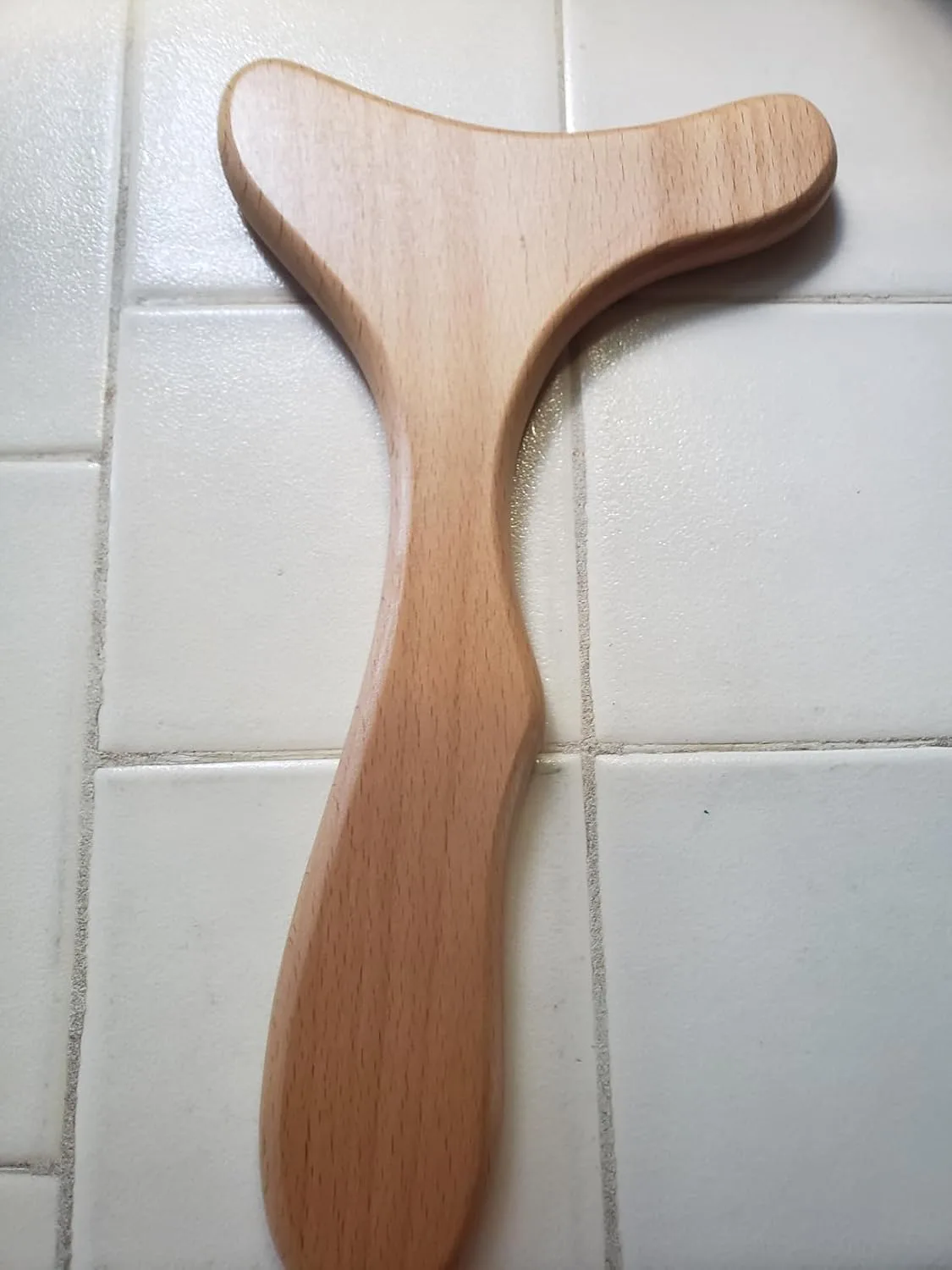 Customer photo of abdominal self-massage tool being used on stomach area