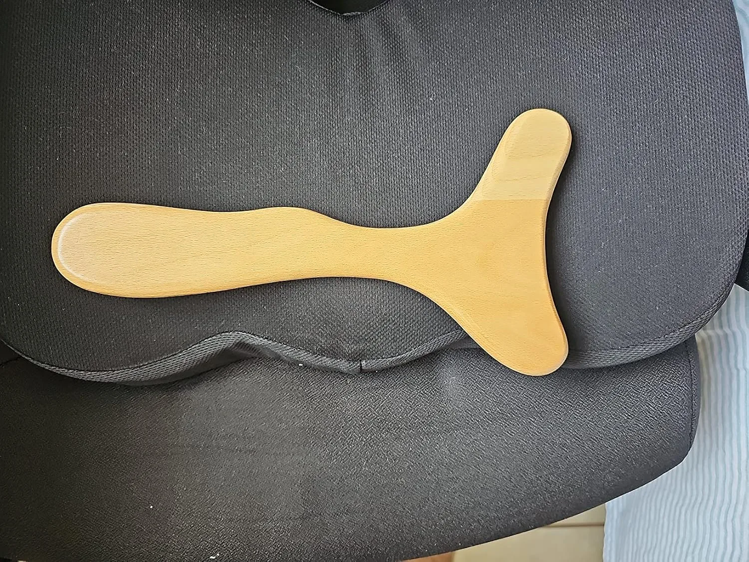 Customer photo of abdominal self-massage tool showing the device's design and size
