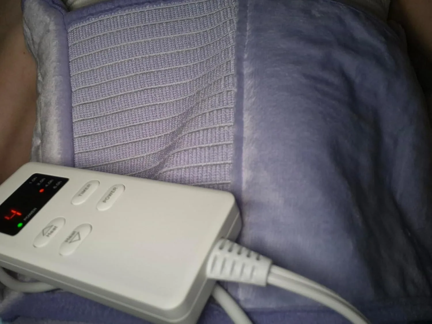Customer photo of heating pad applied to stomach area for IBS cramp relief