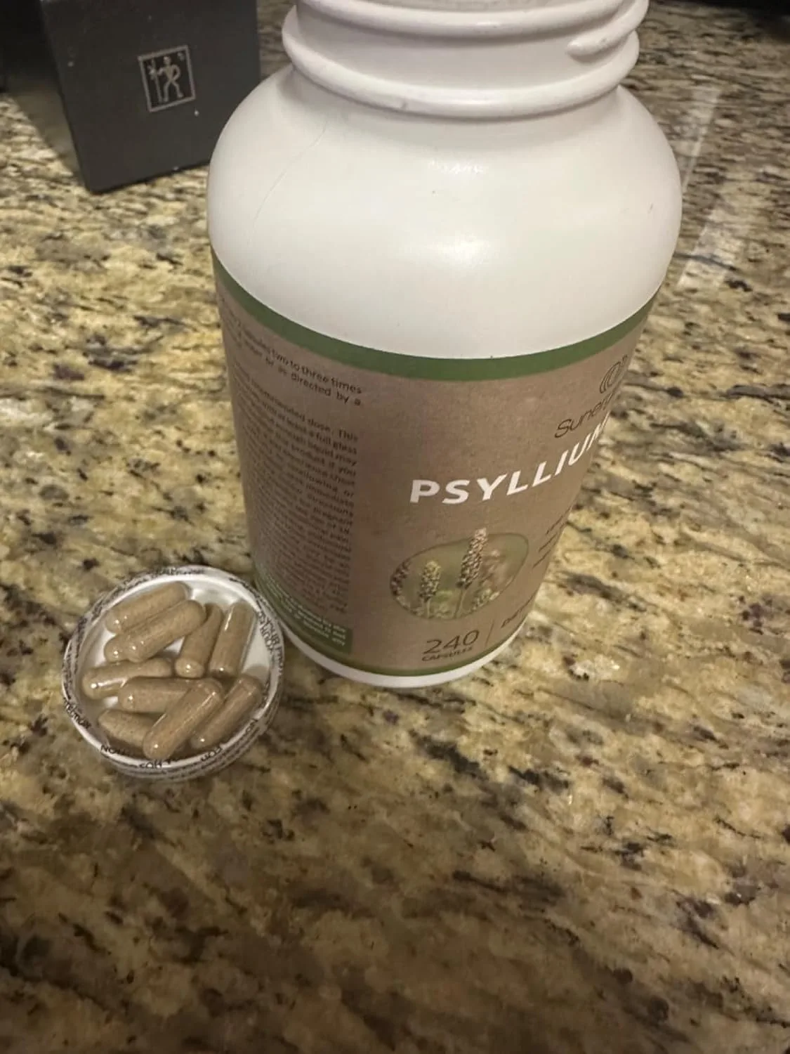 Customer photo of digestive supplement packaging and contents displayed on white surface