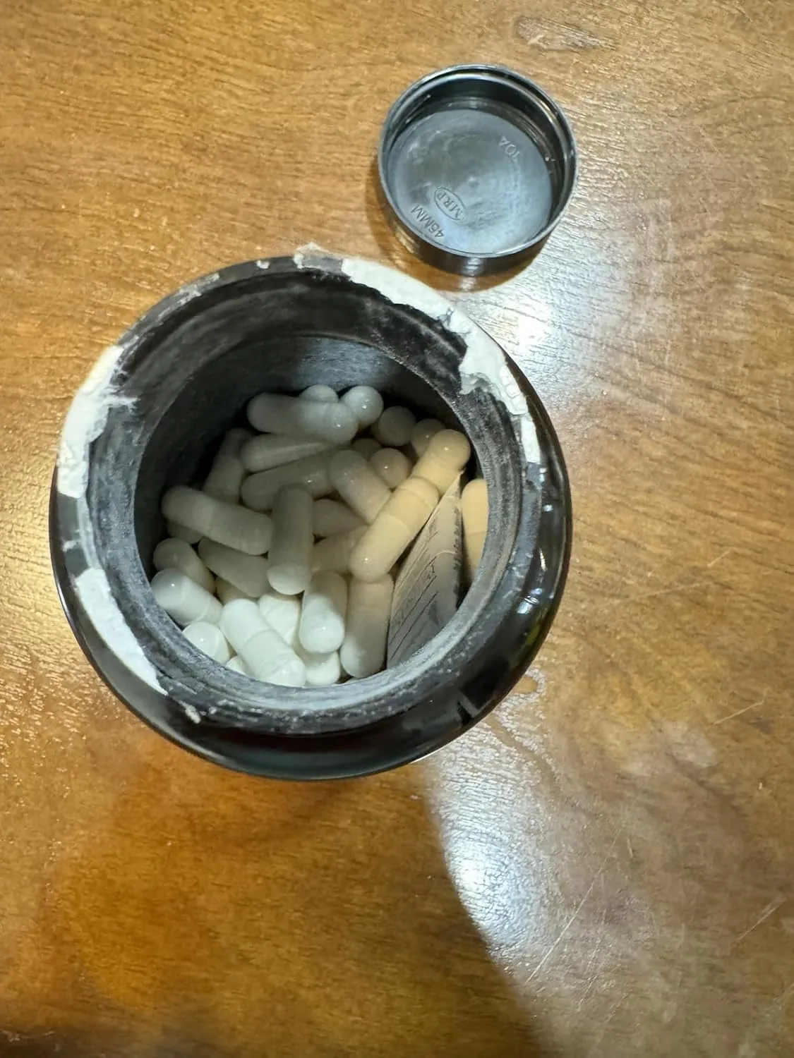 Customer photo of probiotic supplement bottle displayed on kitchen counter
