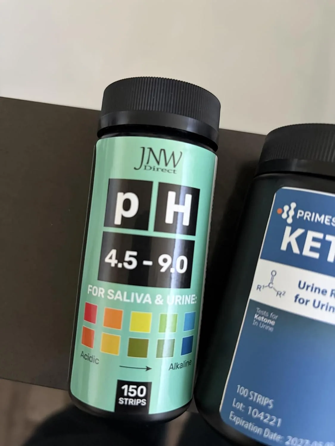 Customer photo of pH test strips being used to test saliva or urine sample