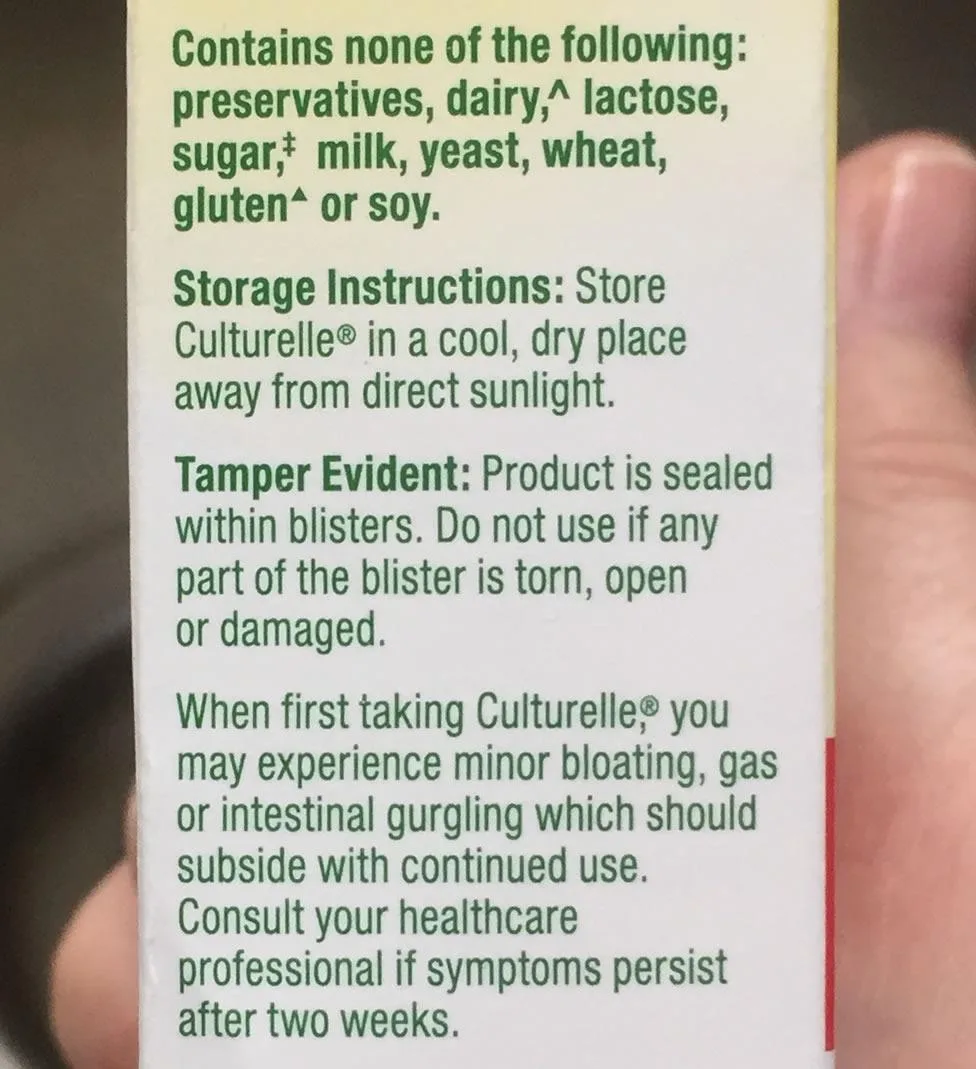 Customer photo of probiotic supplement bottle and capsules displayed on white surface