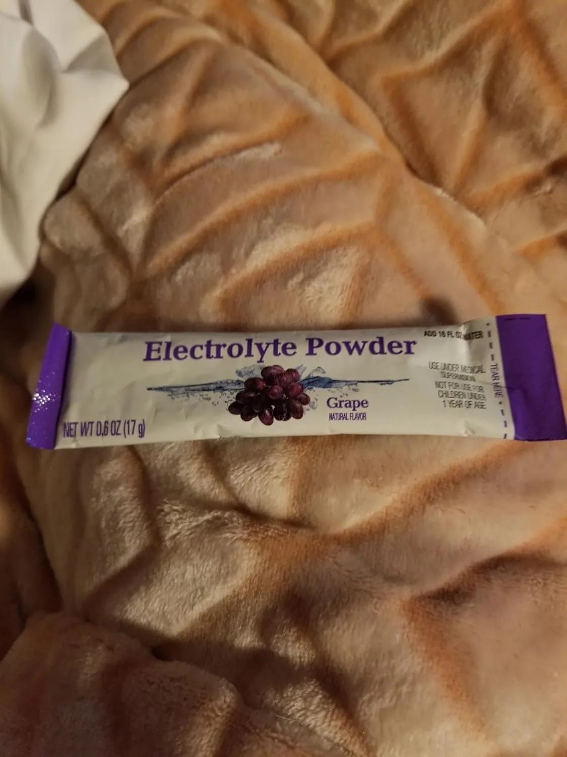 Customer photo of electrolyte rehydration powder sachet with mixing instructions visible