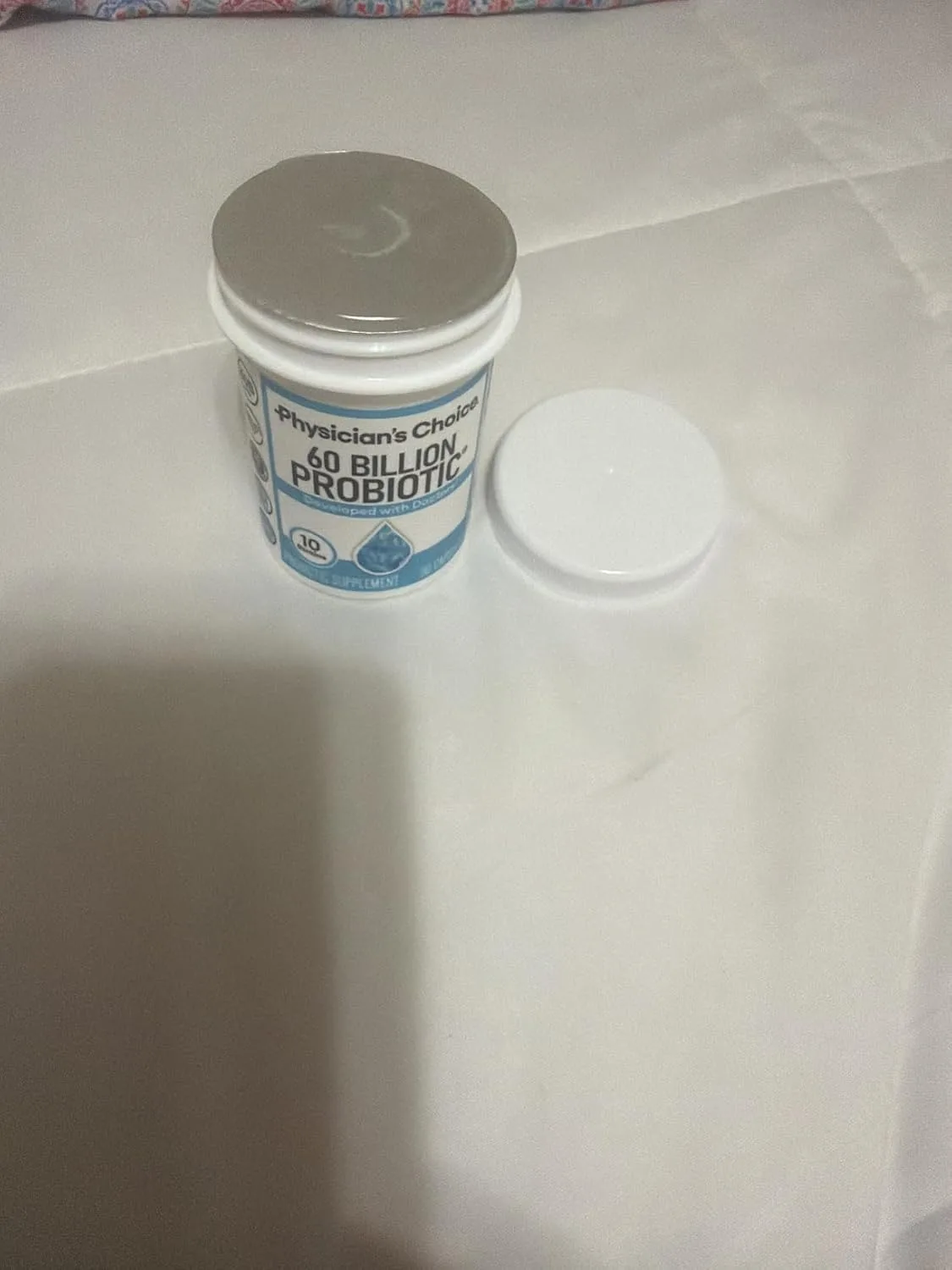 Customer photo of probiotic supplement bottle and capsules displayed together