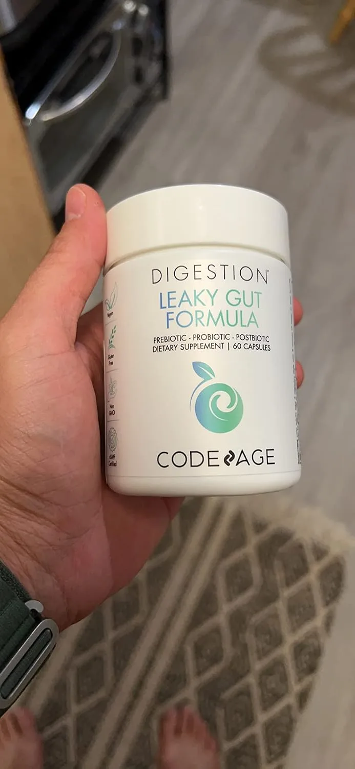 Customer photo of gut health supplement capsules in bottle with label visible