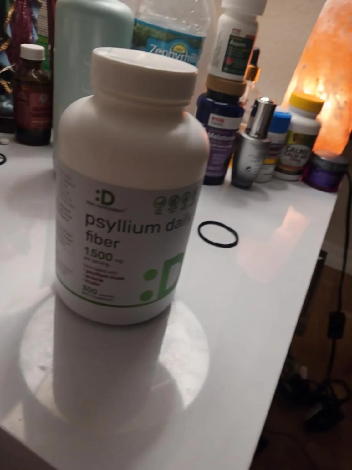 Customer photo of fiber supplement powder in measuring scoop next to glass of water