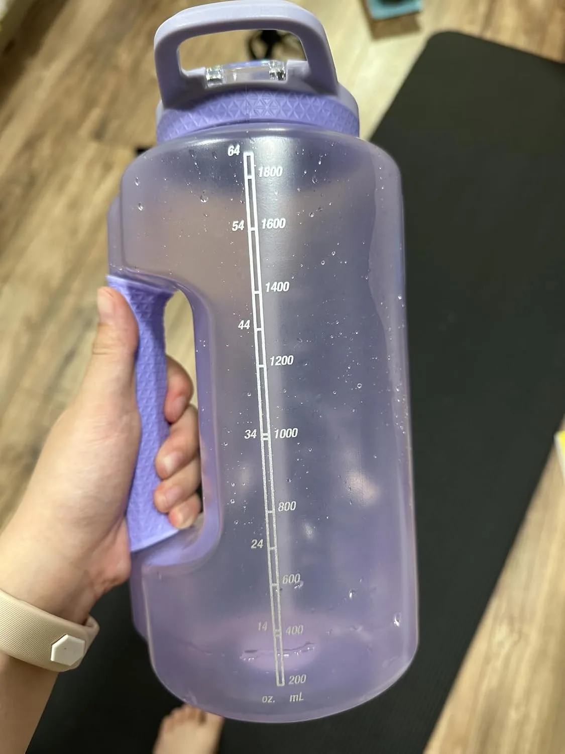 Customer photo of water bottle filled with clear water showing hydration tracking marks