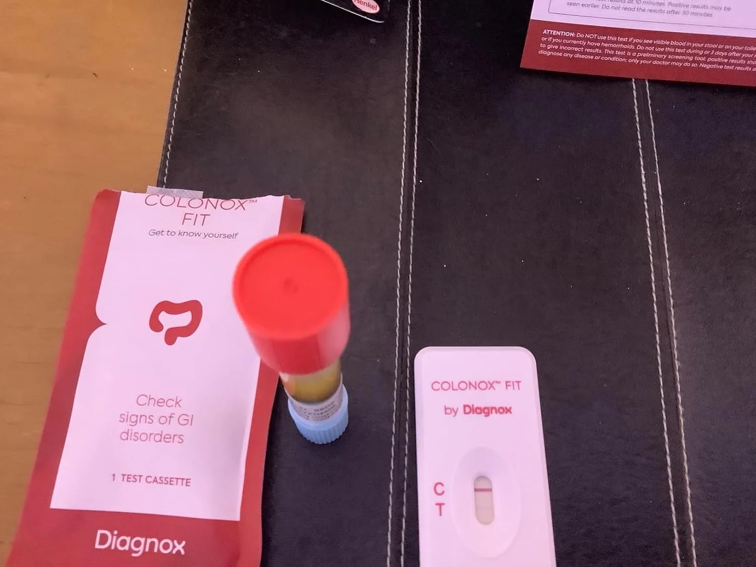 Customer photo of stool test kit box and contents laid out on table