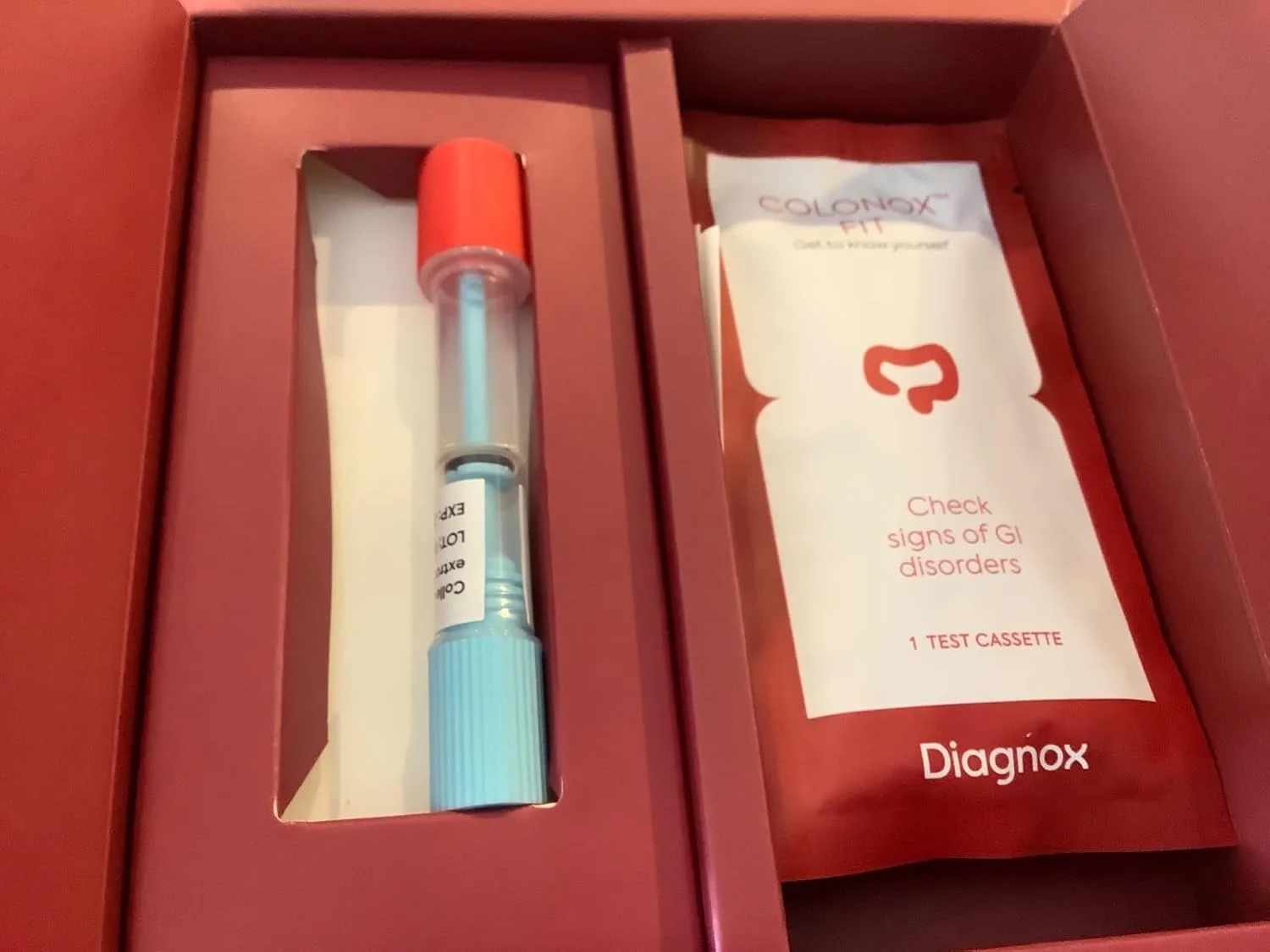 Customer photo of stool test kit components laid out showing collection materials