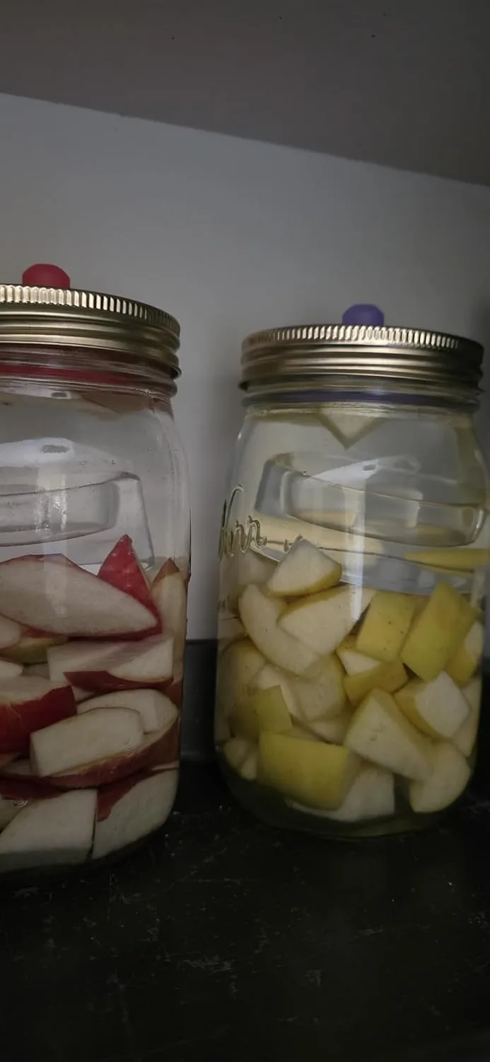 Customer photo of finished homemade sauerkraut in a glass jar with visible fermentation