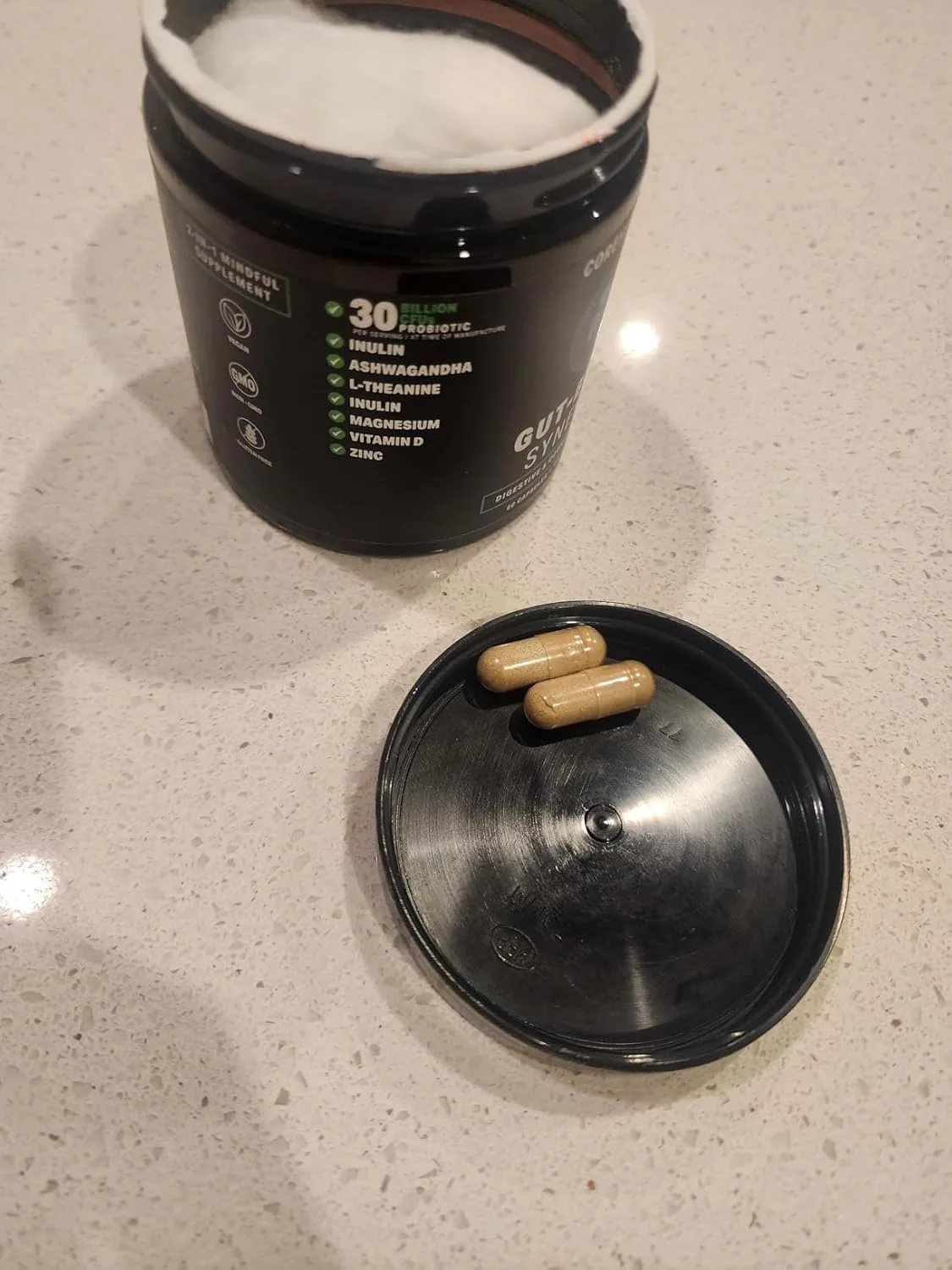 Customer photo of gut health supplement bottle displaying ingredient label and packaging