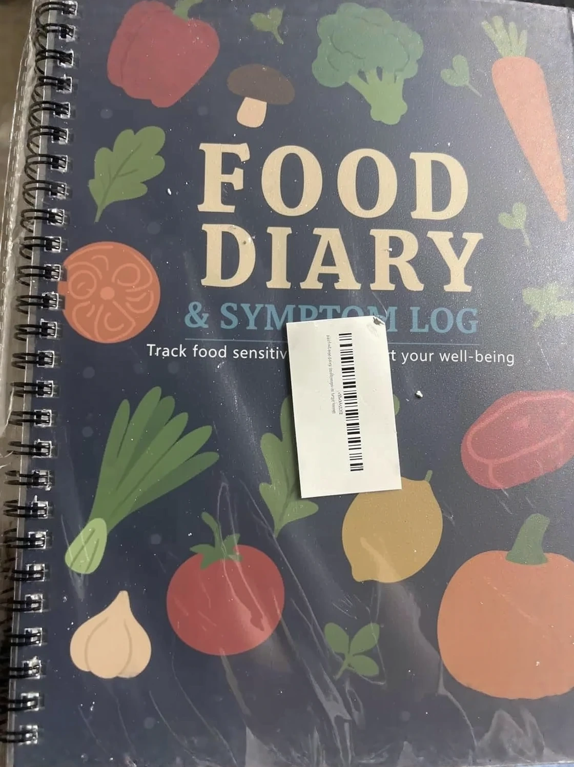 Customer photo of open food diary journal showing daily symptom tracking pages with handwritten entries