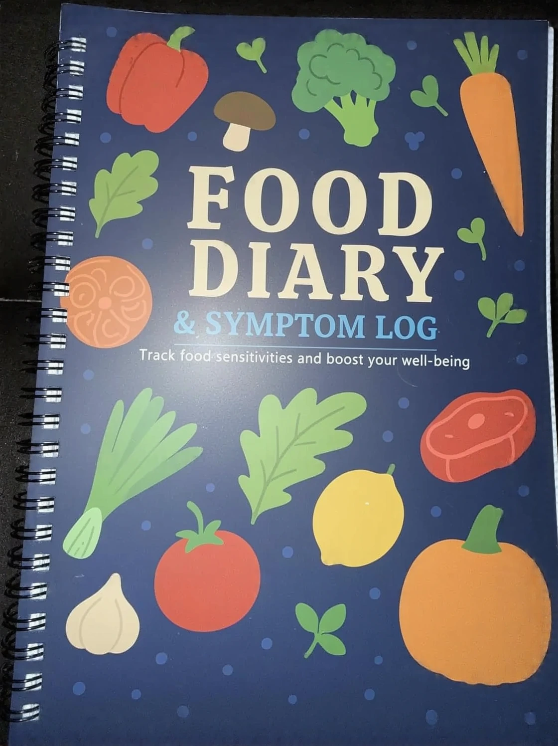 Customer photo of food diary journal pages with handwritten food and symptom entries