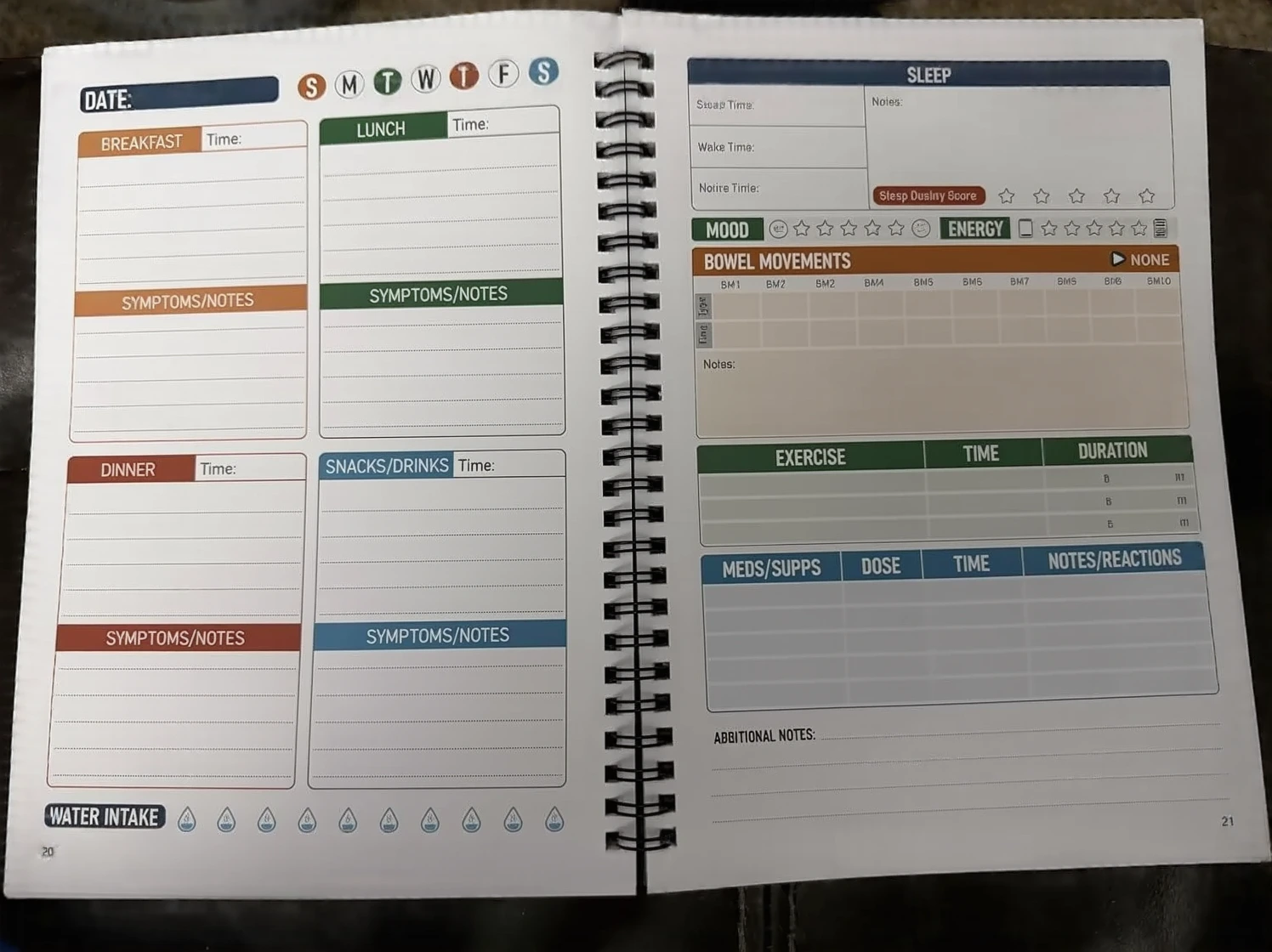 Customer photo of food diary journal pages filled with handwritten food entries and symptom notes